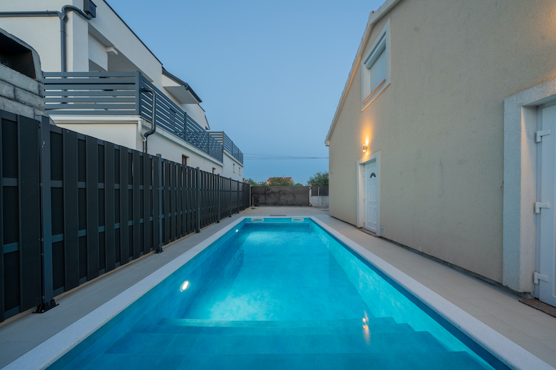 House exterior with pool at dusk